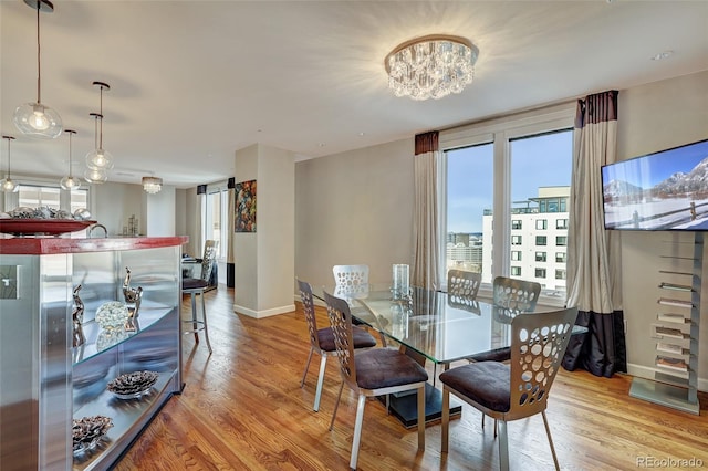 dining area featuring baseboards and wood finished floors