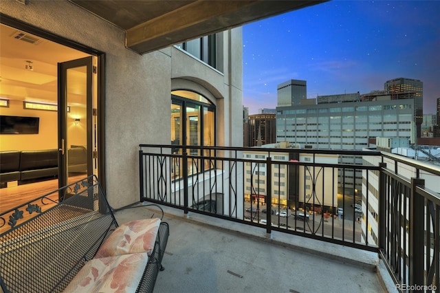 balcony with visible vents and a city view