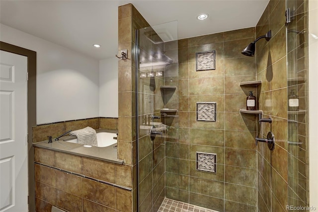 bathroom with a tile shower and recessed lighting