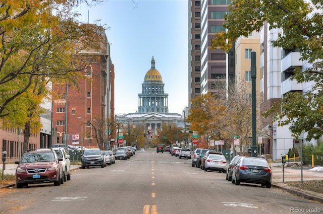 view of street with curbs, traffic signs, and sidewalks