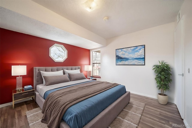 12113 Melody Dr Unit 304, Westminster, CO 80234 - bedroom featuring wood finished floors and baseboards