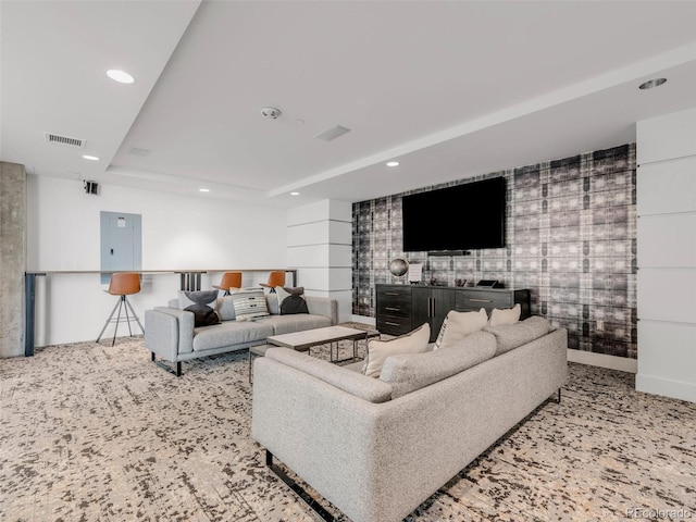 carpeted living room with recessed lighting, visible vents, baseboards, electric panel, and a raised ceiling