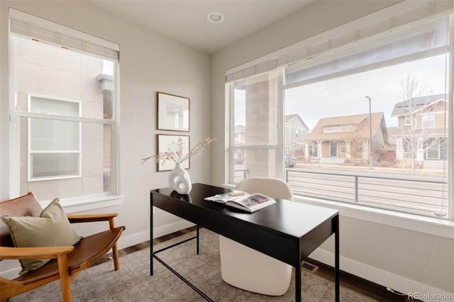 office featuring visible vents, baseboards, and wood finished floors