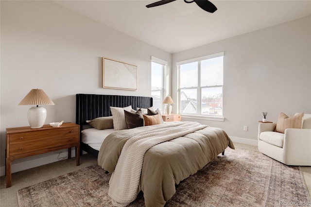 bedroom featuring carpet, baseboards, and a ceiling fan