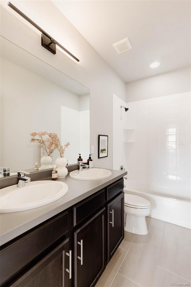 bathroom featuring double vanity, toilet, tile patterned flooring, bathtub / shower combination, and a sink