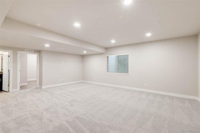 finished basement featuring baseboards, recessed lighting, visible vents, and light colored carpet