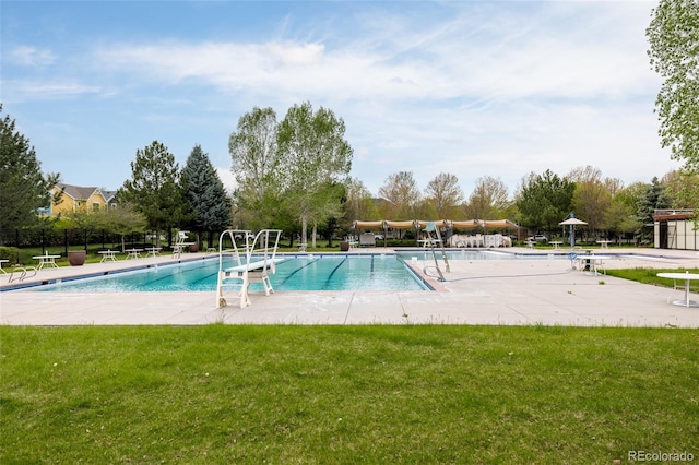 community pool featuring a yard and a patio