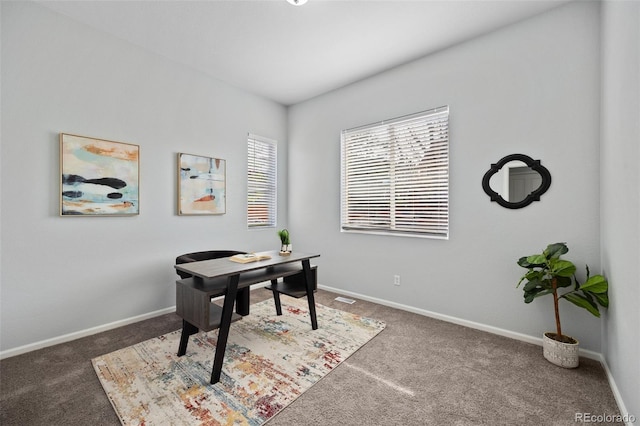 carpeted home office with baseboards