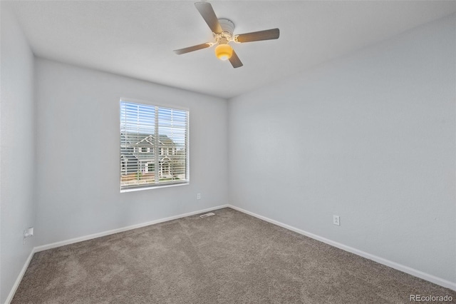 carpeted empty room featuring baseboards, a ceiling fan, and visible vents