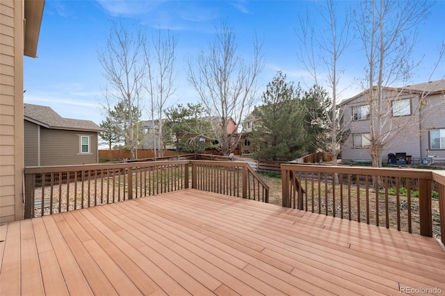 wooden deck with a residential view and a fenced backyard