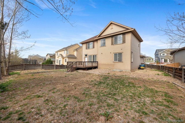 back of property featuring a fenced backyard, a deck, and a residential view
