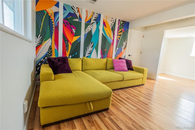 living room featuring baseboards and wood finished floors