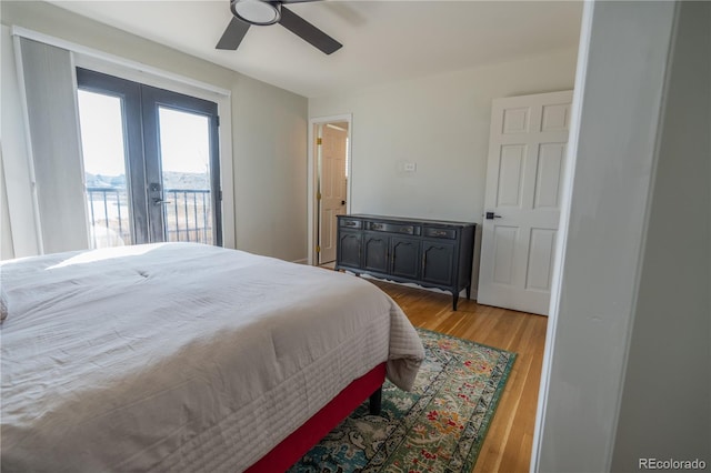 bedroom with ceiling fan, french doors, wood finished floors, and access to outside