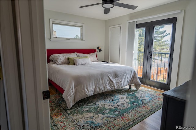 bedroom featuring access to outside, multiple windows, french doors, and wood finished floors
