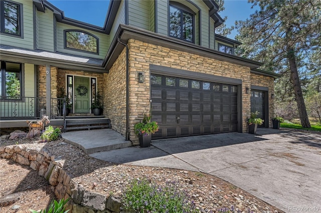 1410 Old Sequoia Ct, Franktown, CO 80116 - entrance to property featuring concrete driveway, a porch, stone siding, and a garage