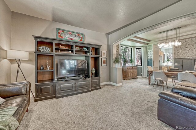 1410 Old Sequoia Ct, Franktown, CO 80116 - carpeted living area featuring arched walkways, baseboards, and a textured ceiling