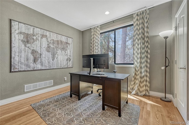 1410 Old Sequoia Ct, Franktown, CO 80116 - home office with wood finished floors, baseboards, and a textured wall