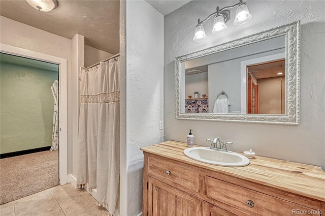 1410 Old Sequoia Ct, Franktown, CO 80116 - full bath with a textured wall, vanity, tile patterned floors, and a shower with shower curtain