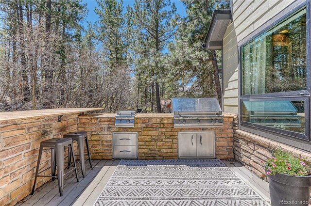 1410 Old Sequoia Ct, Franktown, CO 80116 - view of patio featuring grilling area, an outdoor kitchen, a deck, and an outdoor bar
