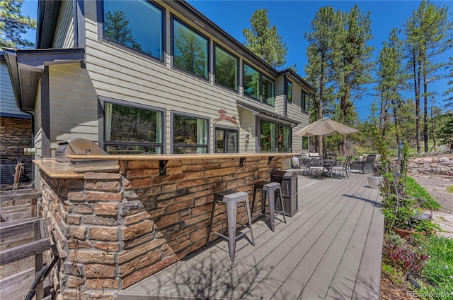 1410 Old Sequoia Ct, Franktown, CO 80116 - wooden deck featuring exterior kitchen, outdoor dining space, and exterior bar