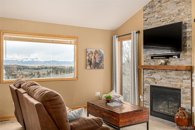 2418 Wells Fargo Cir, Jefferson, CO 80456 - carpeted living room featuring baseboards, a stone fireplace, and vaulted ceiling