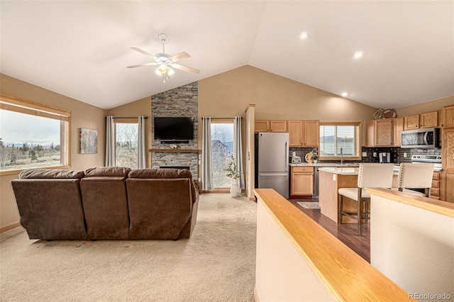 2418 Wells Fargo Cir, Jefferson, CO 80456 - living area with a ceiling fan, light carpet, and high vaulted ceiling