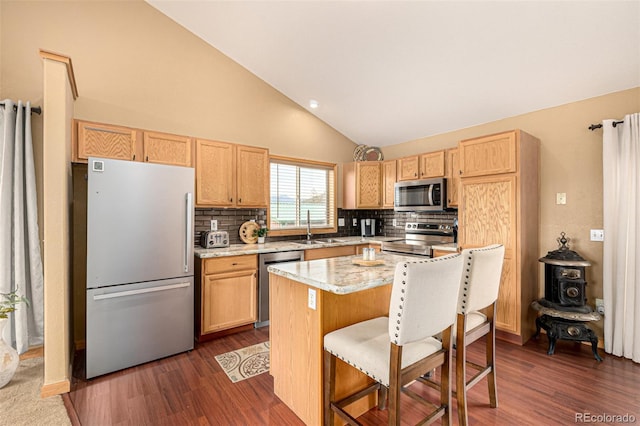 2418 Wells Fargo Cir, Jefferson, CO 80456 - kitchen featuring appliances with stainless steel finishes, dark wood finished floors, decorative backsplash, a breakfast bar area, and high vaulted ceiling