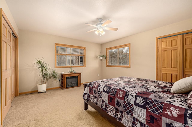 2418 Wells Fargo Cir, Jefferson, CO 80456 - bedroom with carpet, baseboards, a glass covered fireplace, ceiling fan, and a closet