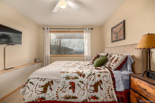2418 Wells Fargo Cir, Jefferson, CO 80456 - carpeted bedroom with baseboards, ceiling fan, and a textured wall