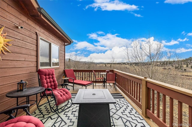 2418 Wells Fargo Cir, Jefferson, CO 80456 - wooden terrace featuring an outdoor living space with a fire pit
