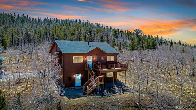 2418 Wells Fargo Cir, Jefferson, CO 80456 - back of house with a wooded view, a wooden deck, and stairs