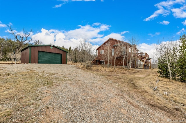 2418 Wells Fargo Cir, Jefferson, CO 80456 - view of outdoor structure featuring stairway and dirt driveway