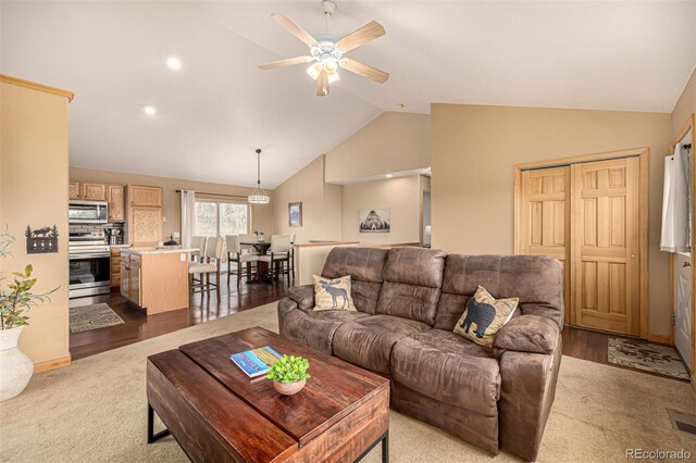 2418 Wells Fargo Cir, Jefferson, CO 80456 - living area with ceiling fan, wood finished floors, and high vaulted ceiling
