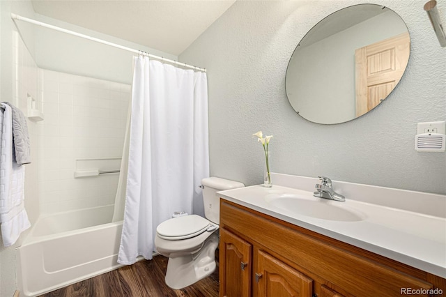 2418 Wells Fargo Cir, Jefferson, CO 80456 - bathroom with wood finished floors, vanity, toilet, shower / bath combo with shower curtain, and a textured wall