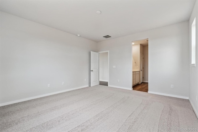 14424 Heritage Dr, Mead, CO 80504 - unfurnished bedroom with dark colored carpet and connected bathroom