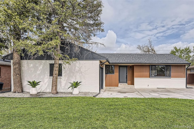 920 S Hudson St, Denver, CO 80246 - mid-century home featuring a front yard, brick siding, roof with shingles, and a patio
