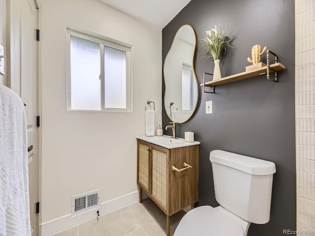920 S Hudson St, Denver, CO 80246 - bathroom with toilet, vanity, baseboards, and tile patterned floors