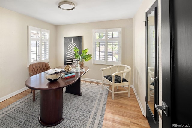 dining room featuring light wood-style floors and baseboards