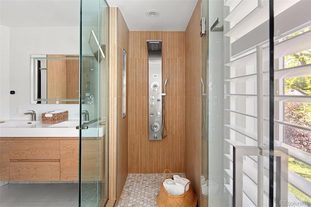 full bathroom featuring a shower stall, vanity, and tile patterned flooring