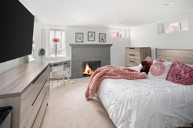 bedroom featuring light colored carpet, multiple windows, a brick fireplace, and recessed lighting