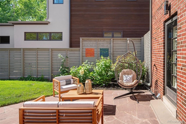 view of patio featuring fence and an outdoor living space