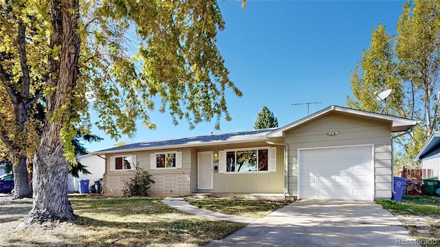 single story home featuring a front lawn and a garage