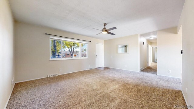 unfurnished room featuring ceiling fan and carpet flooring