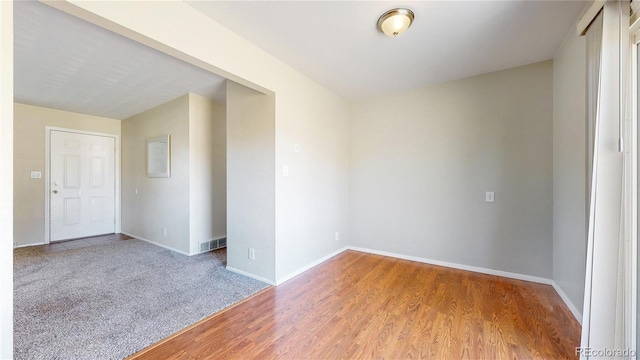 unfurnished room with hardwood / wood-style floors