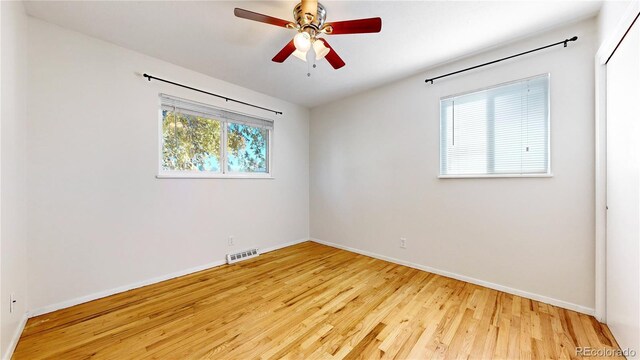 spare room featuring light wood-type flooring and ceiling fan