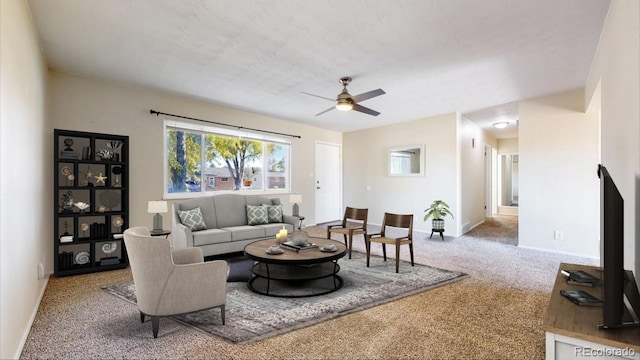 living room featuring carpet flooring and ceiling fan