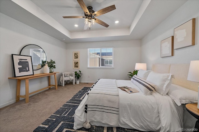 bedroom featuring recessed lighting, a raised ceiling, a ceiling fan, carpet flooring, and baseboards