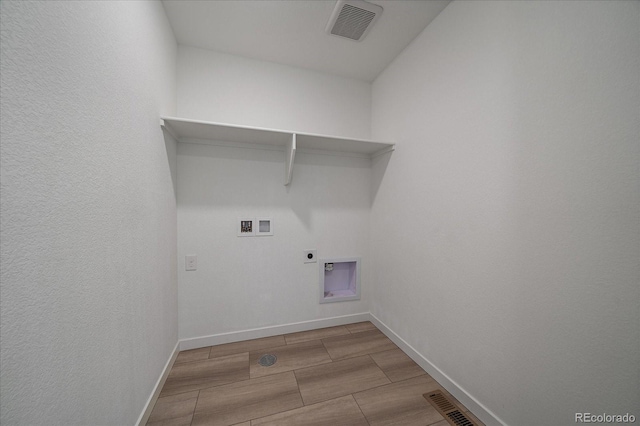 laundry room with laundry area, visible vents, wood tiled floor, washer hookup, and electric dryer hookup