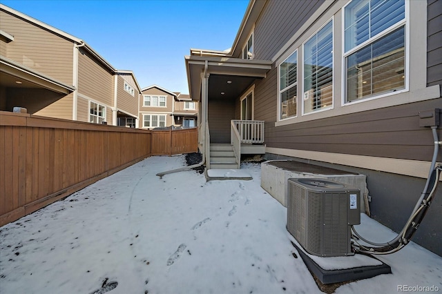 view of yard featuring fence and central AC