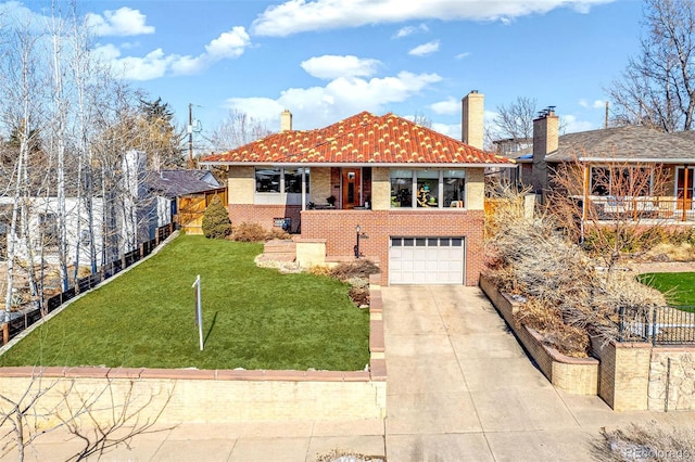 view of front of home featuring brick siding, a chimney, concrete driveway, an attached garage, and a front yard